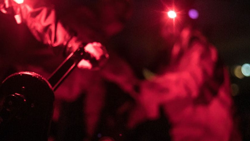 Red light shining on a blurred background with people