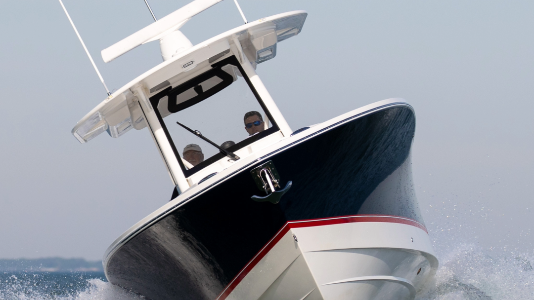 Boat speeding on water with a clear sky background